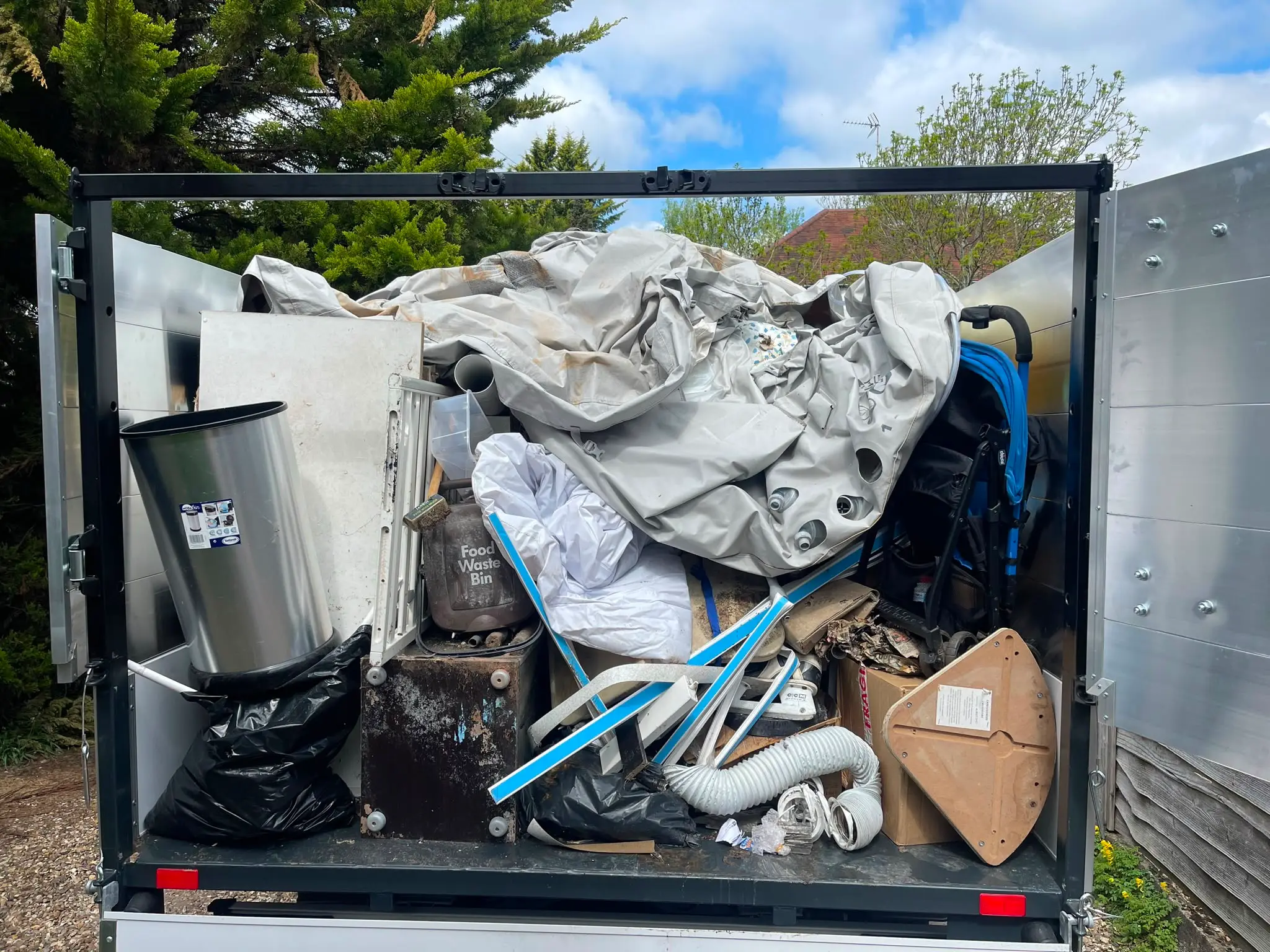 Vehicle loaded with bulky household waste Clearance vehicle loaded with bulky household waste, bagged items and a bicycle frame.